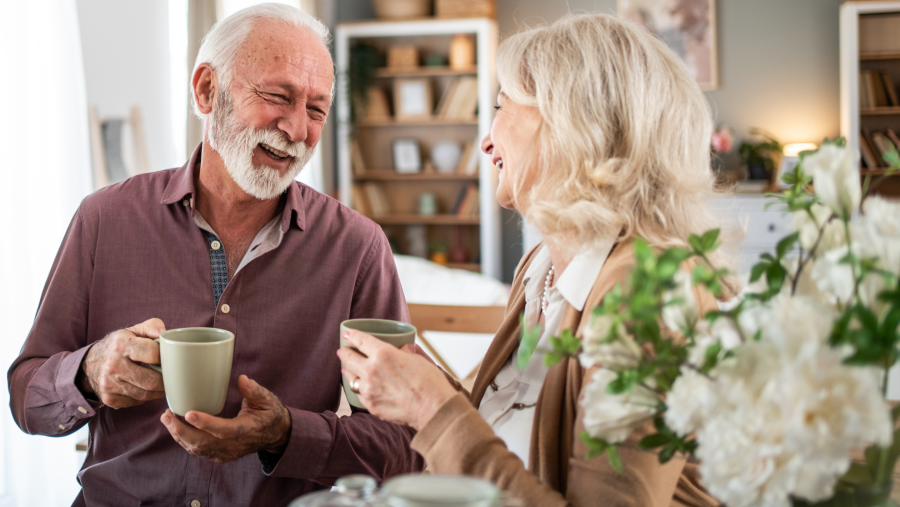 couple smiling over a cup of tea